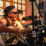 Benjamin partage un moment de transmission rock’n’roll avec Cadillac Rumble pendant les Terrasses Musicales chez Gourmet & Glouton.